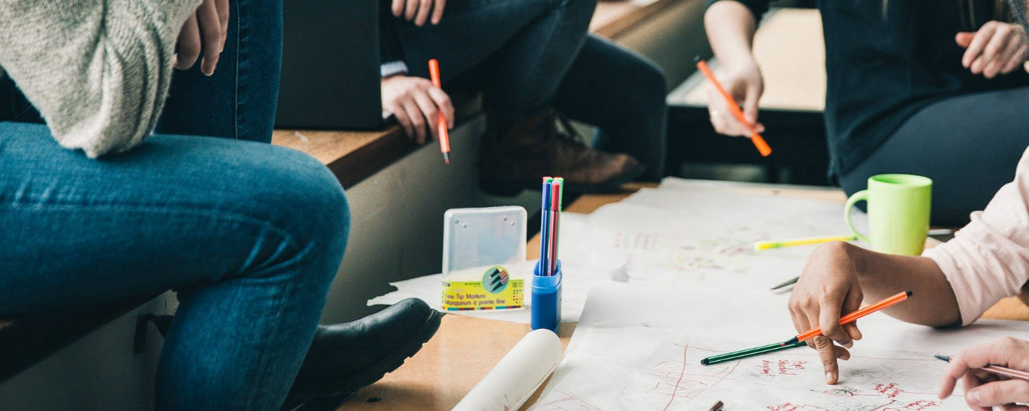 Students around a table planning