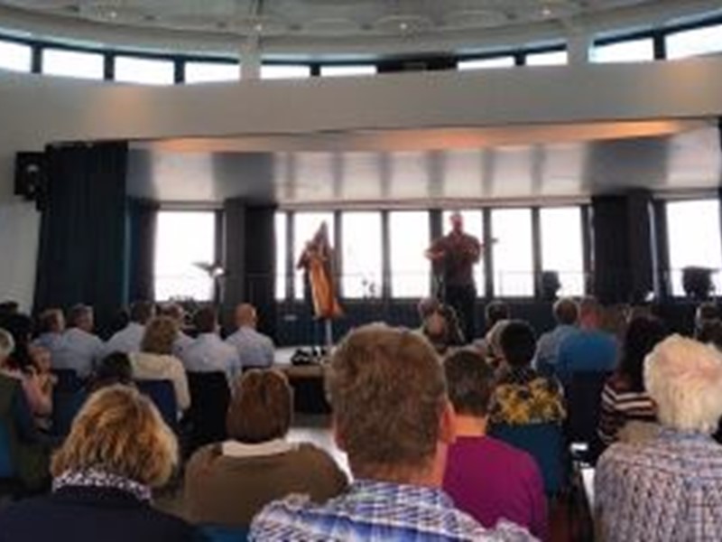 Room of people watching a music performance on stage