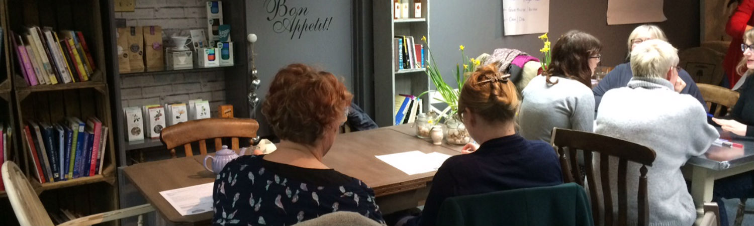 Business women sat around tables discussing business